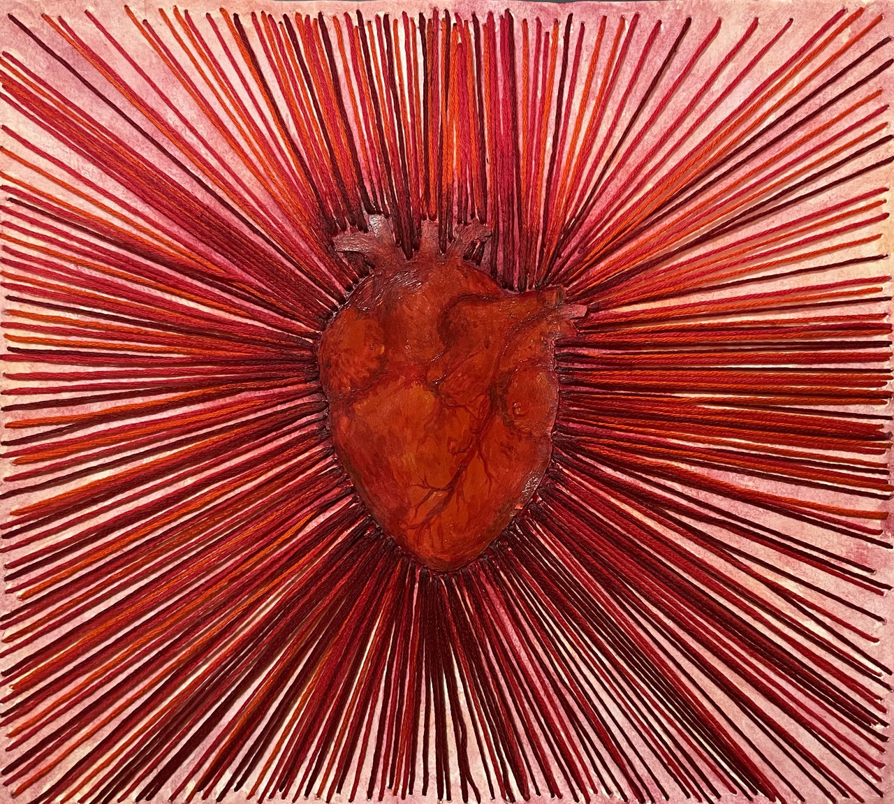 Red heart organ at the center of the art piece surrounded by lines leading to the exterior of the piece.
