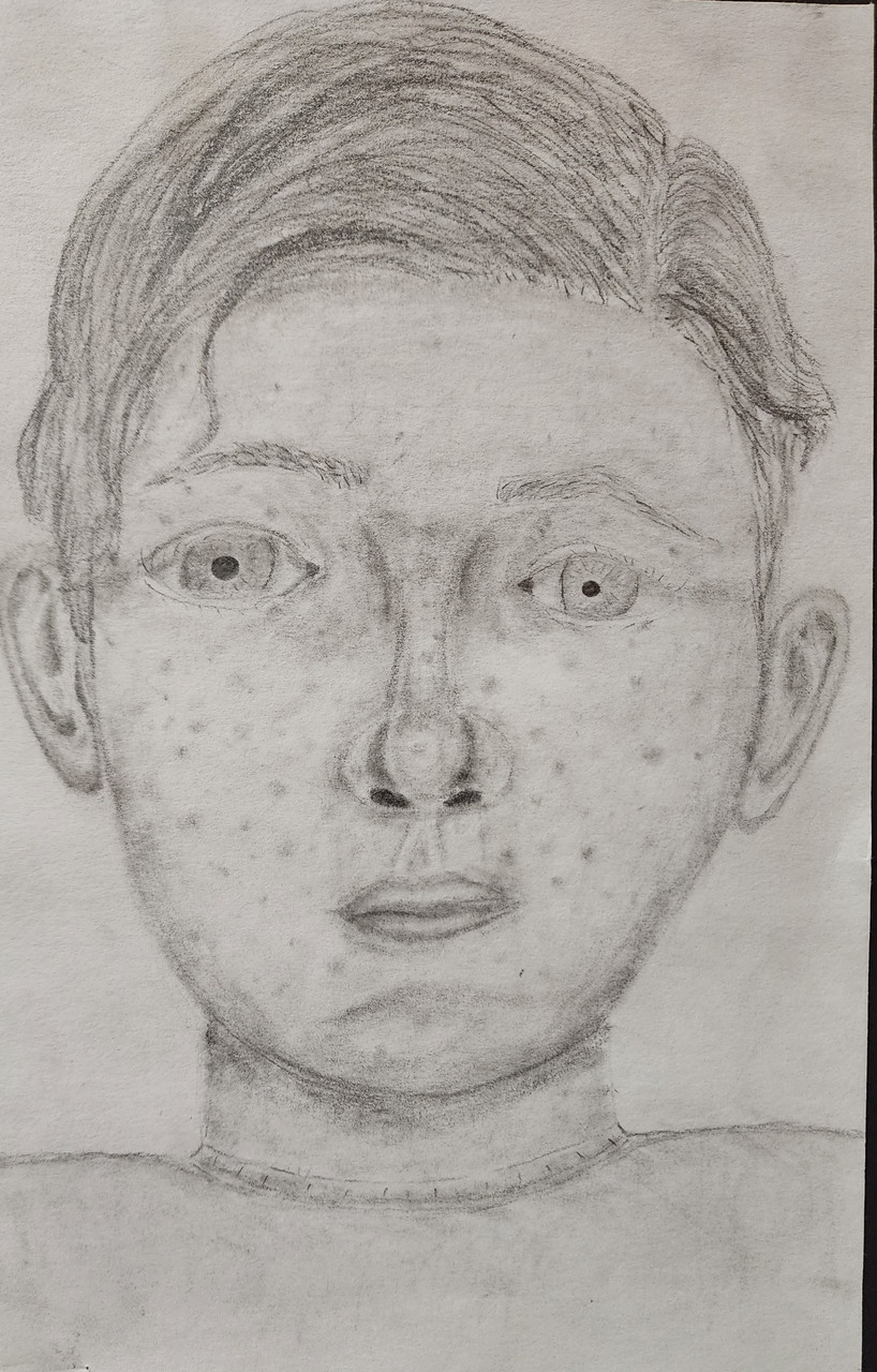 A graphite self-portrait drawing of a person with short hair and freckles.