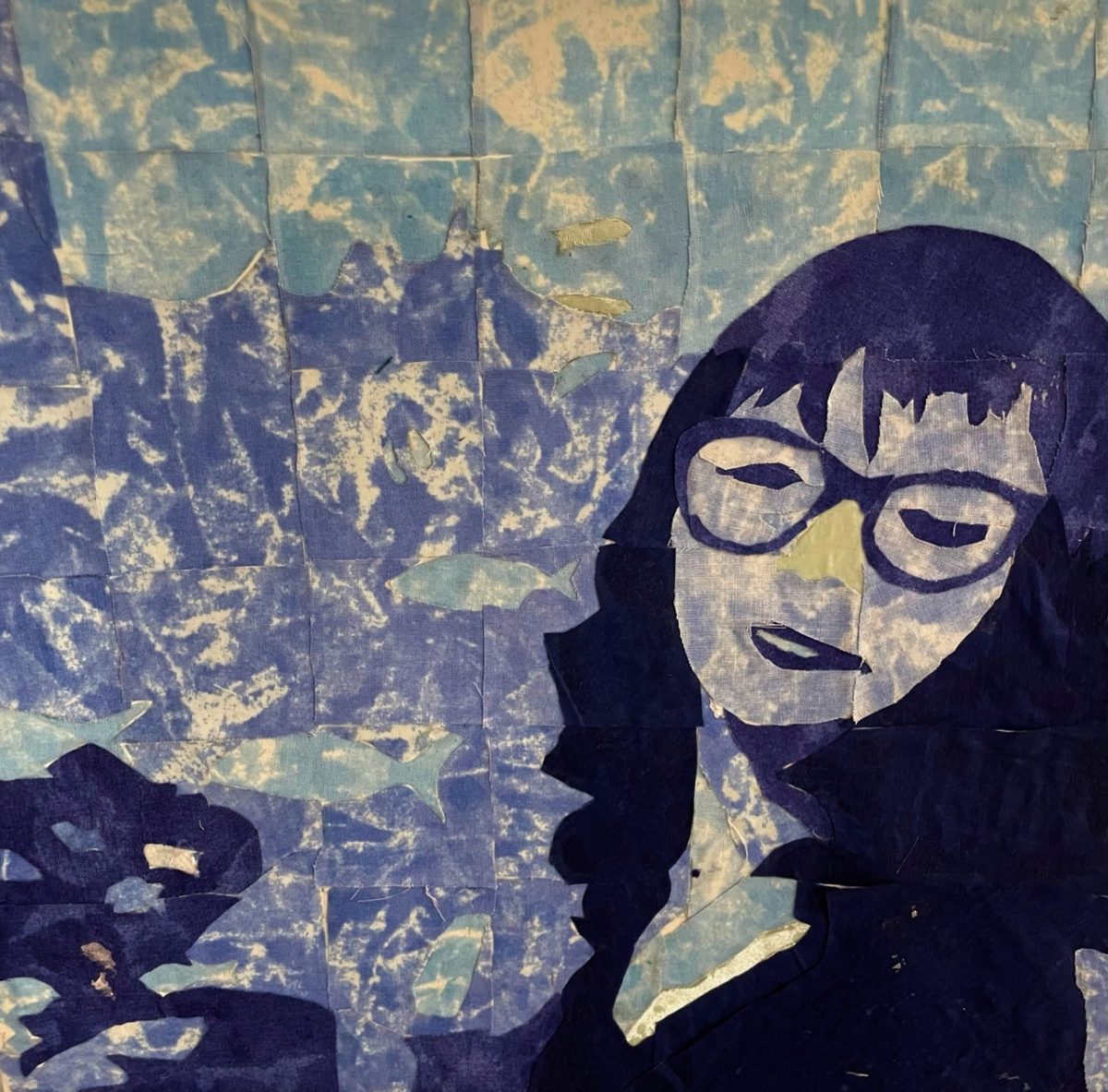 A portrait of a person with bangs wearing glasses made out of cut out blue fabric pieces.