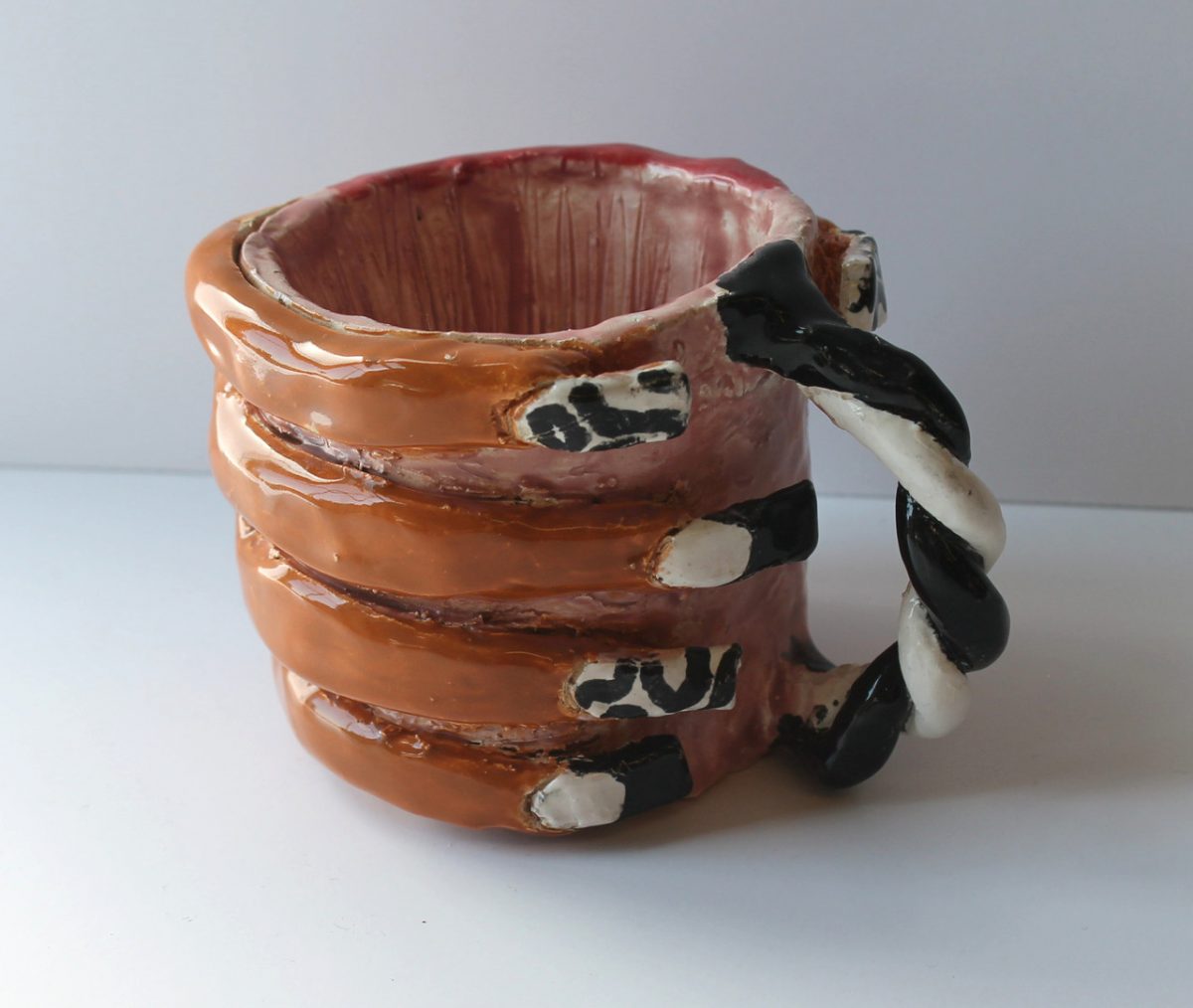 A mug with a black and white handle.
