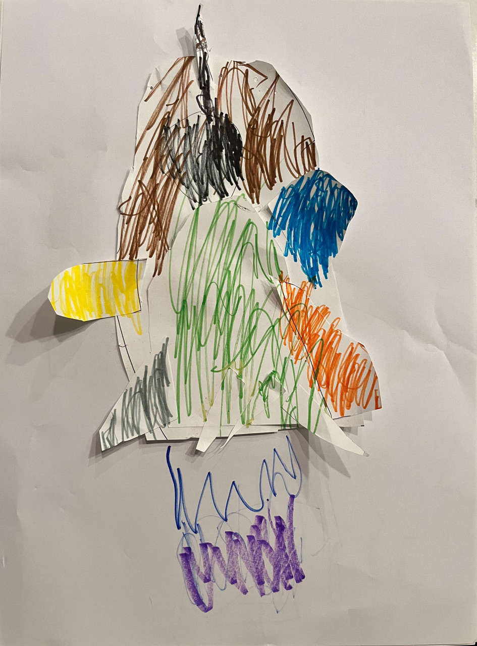 Paper is put together to shape a rocket and colored different colors.