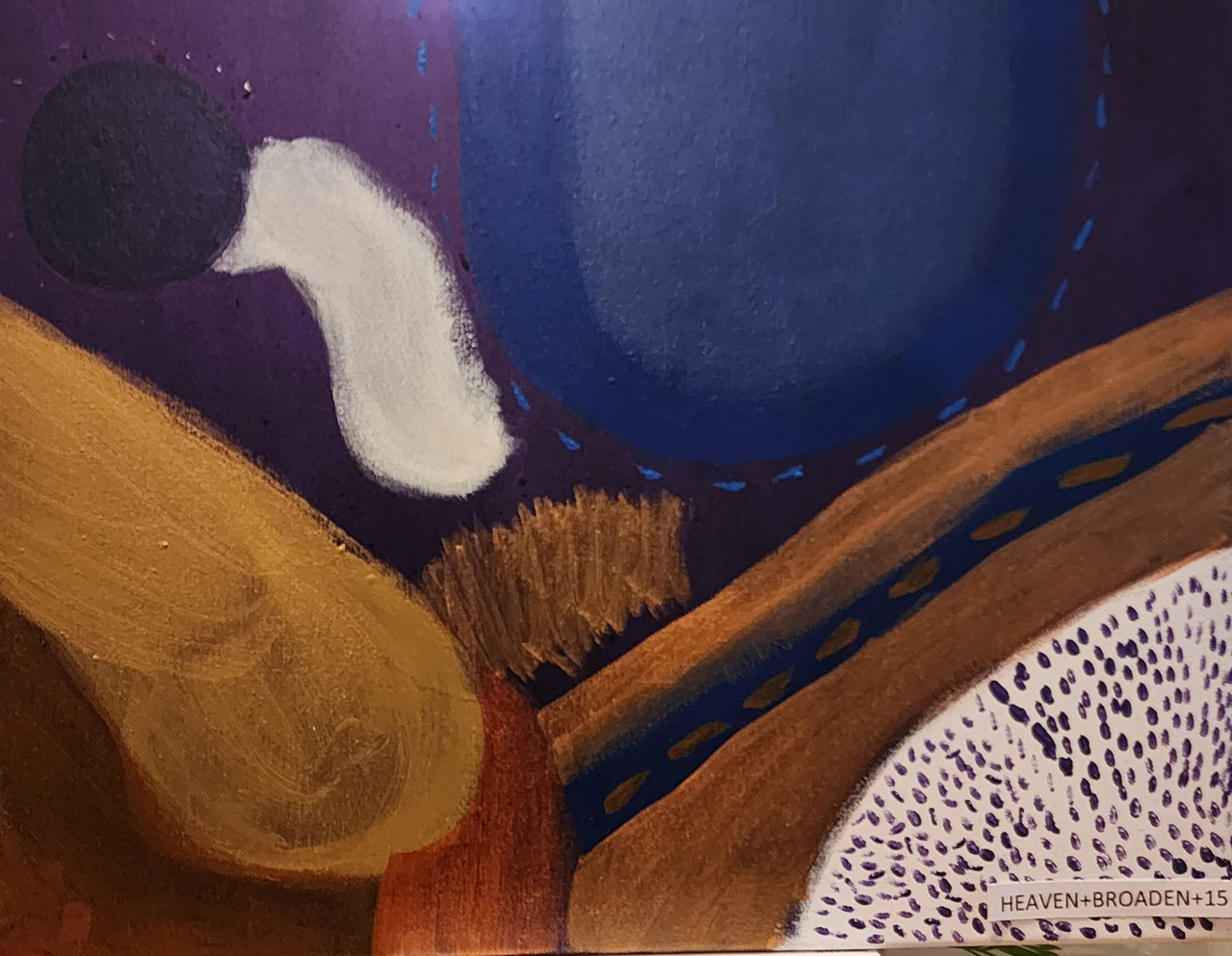 Abstract shapes of gold, blue, and white on an indigo background.