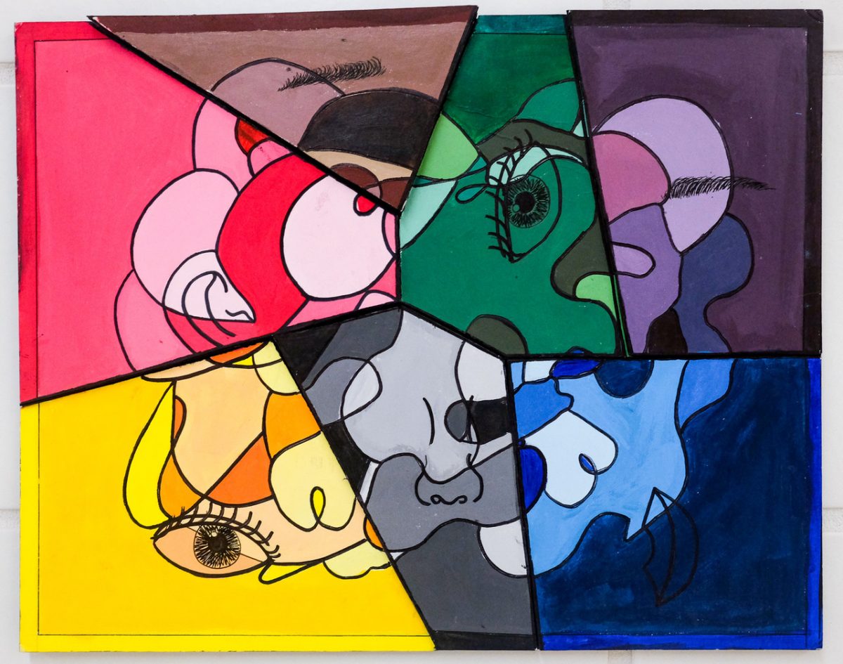 A face made up of rainbow colored puzzle pieces.