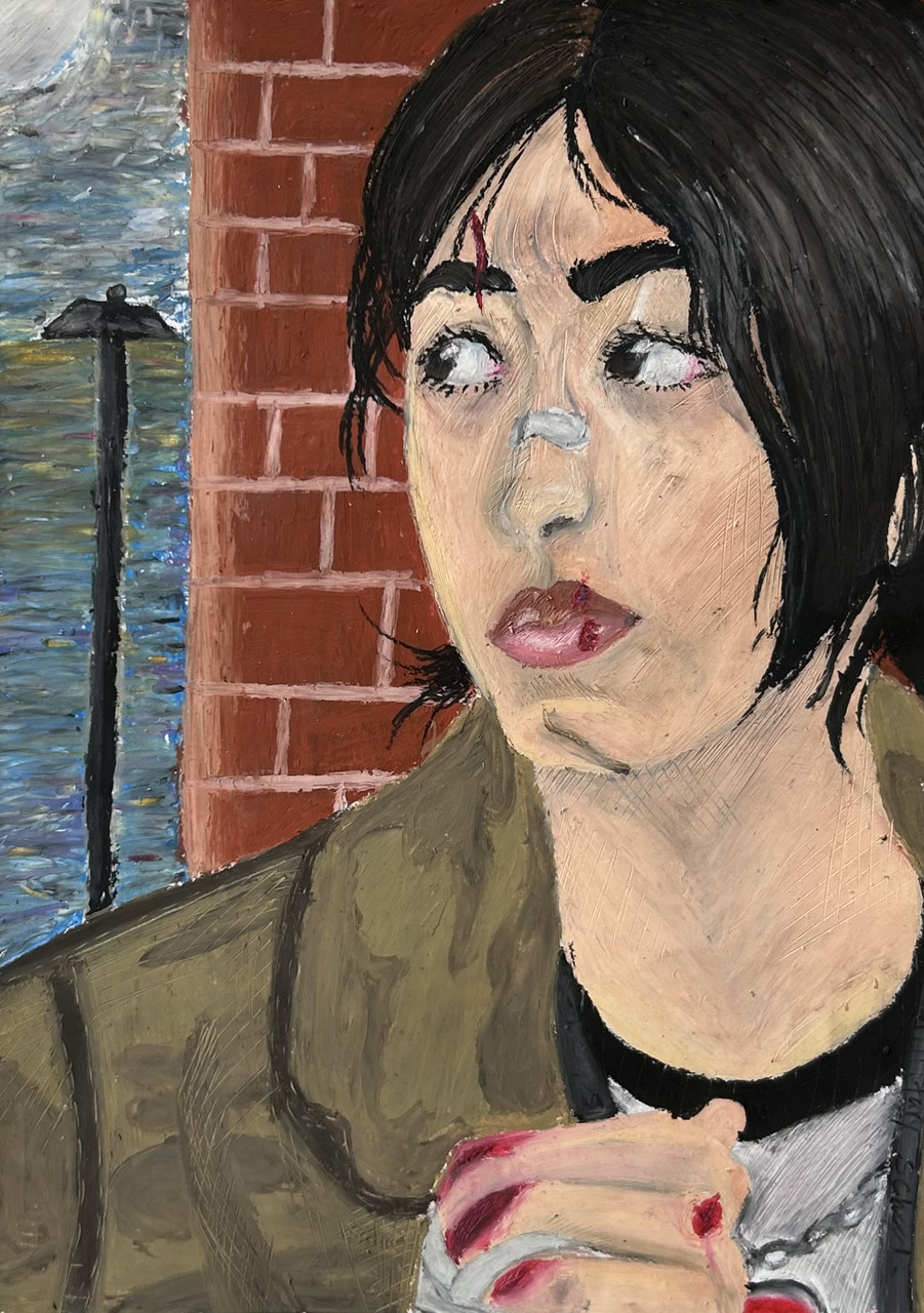 A girl looks to her left as she stands by a brick wall.