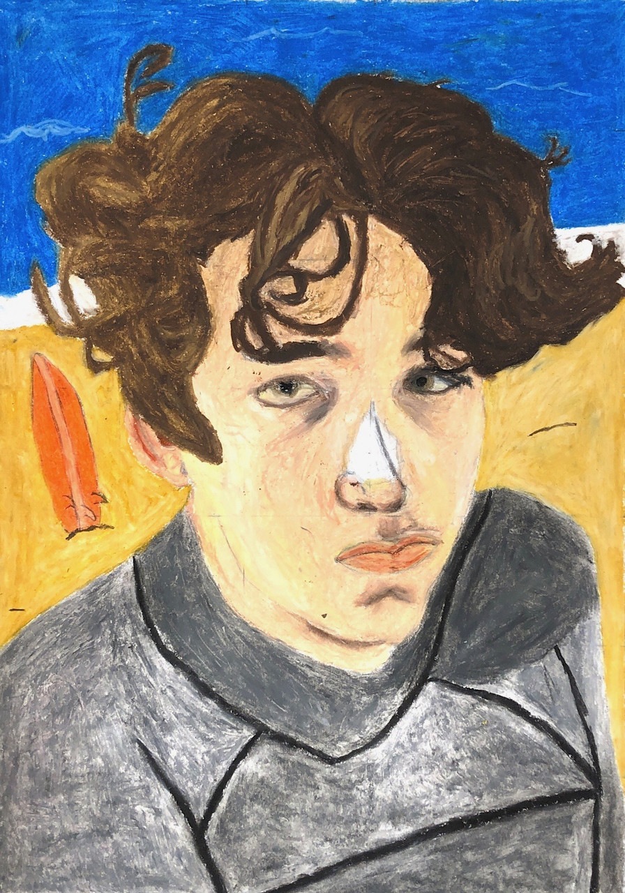 A person's face. Curly short brown hair and a gray jacket.