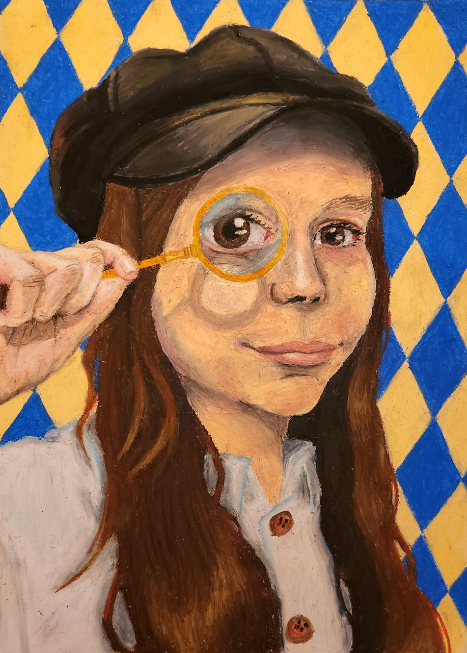 A girl in a hat poses with a magnifying glass.