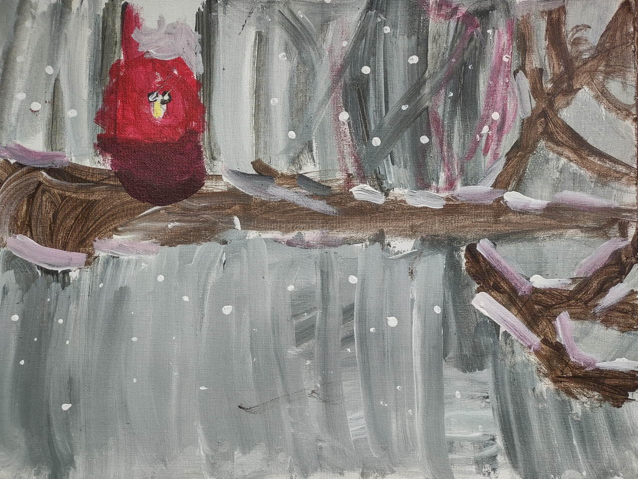 Snowy scene of a red bird on a barren brown tree branch.
