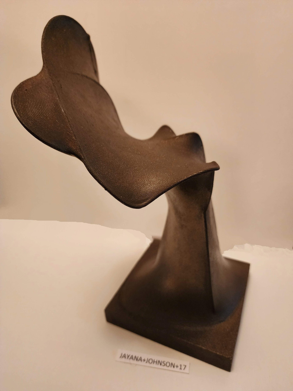Brown, mostly vertical sculpture.