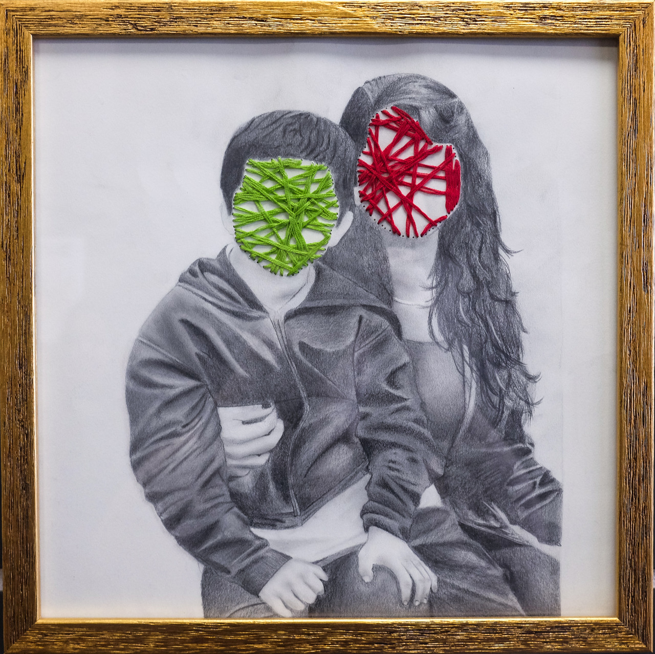 The faces of two children are covered by thread.