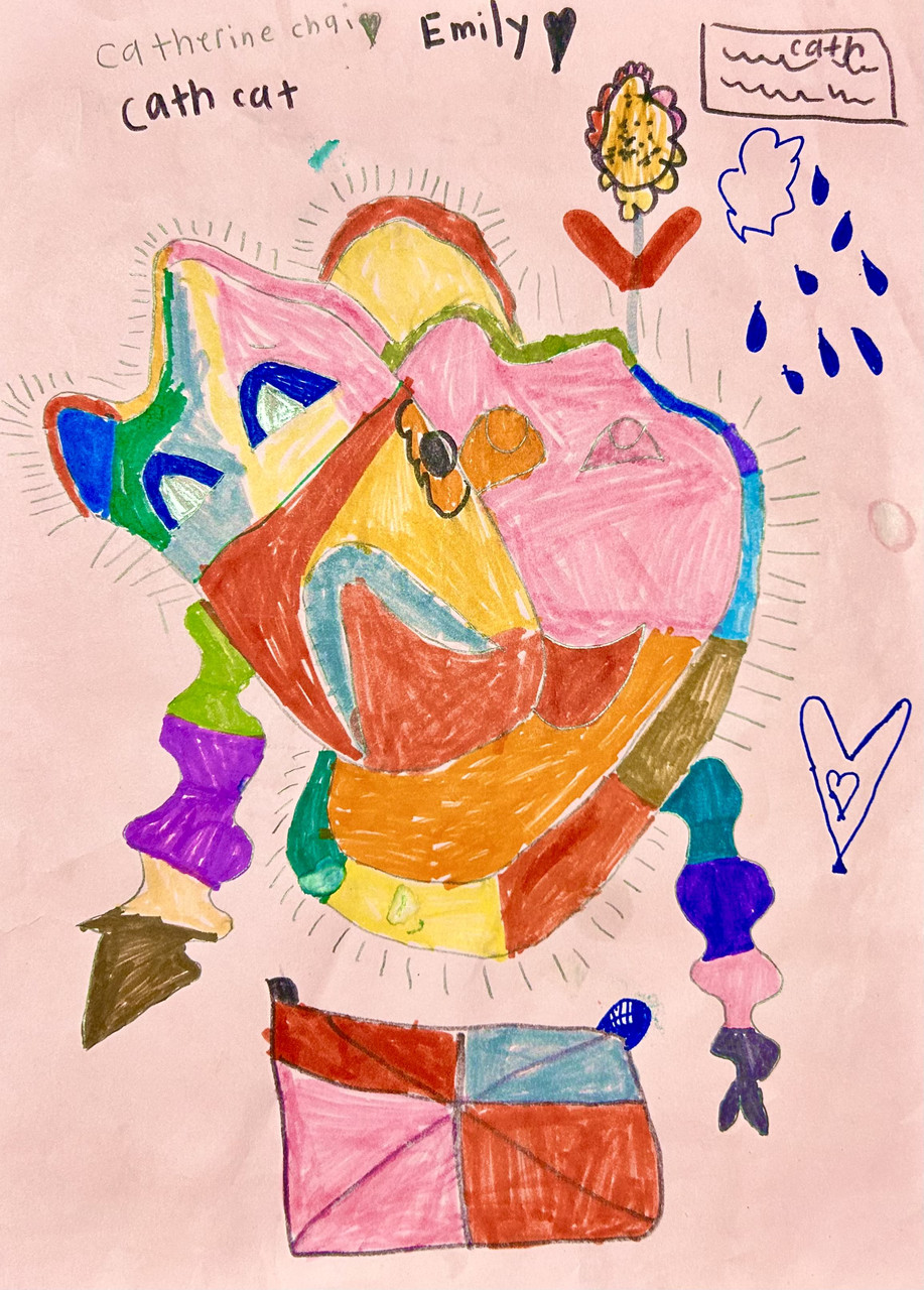 Drawing of a very colorful theater mask on pink paper with multi colored strings hanging from it.