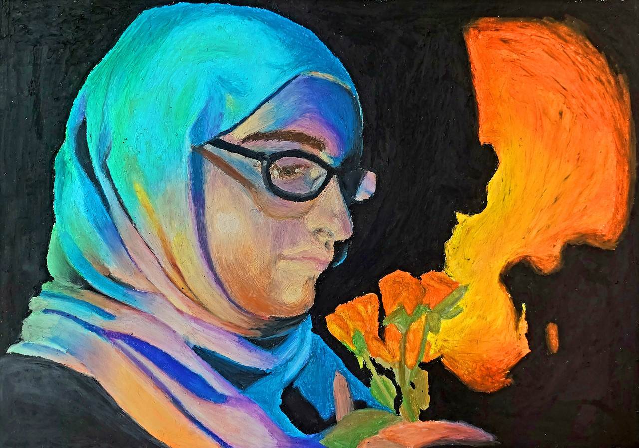 A girl staring at a flower.