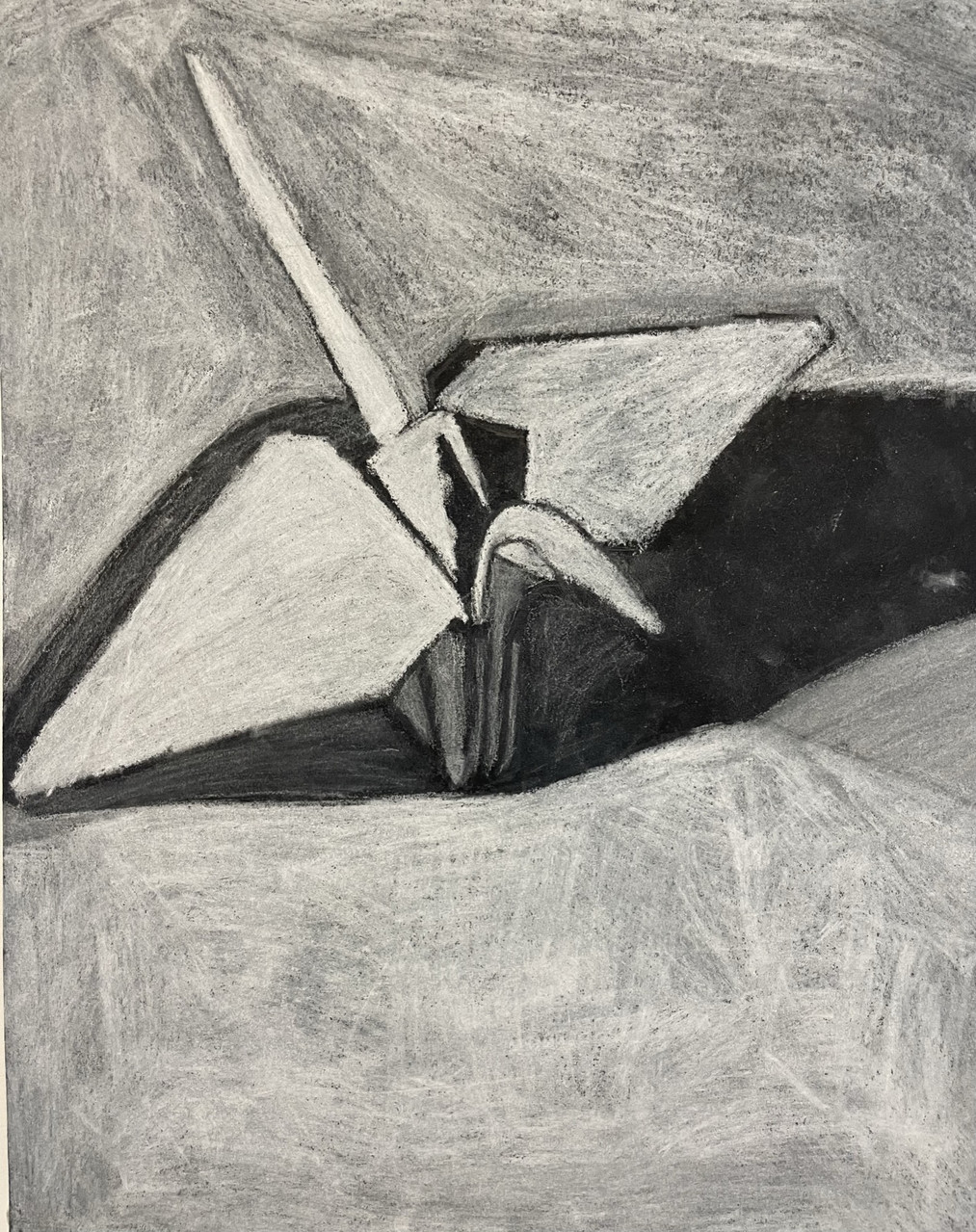 A charcoal drawing of a folded up paper crane.