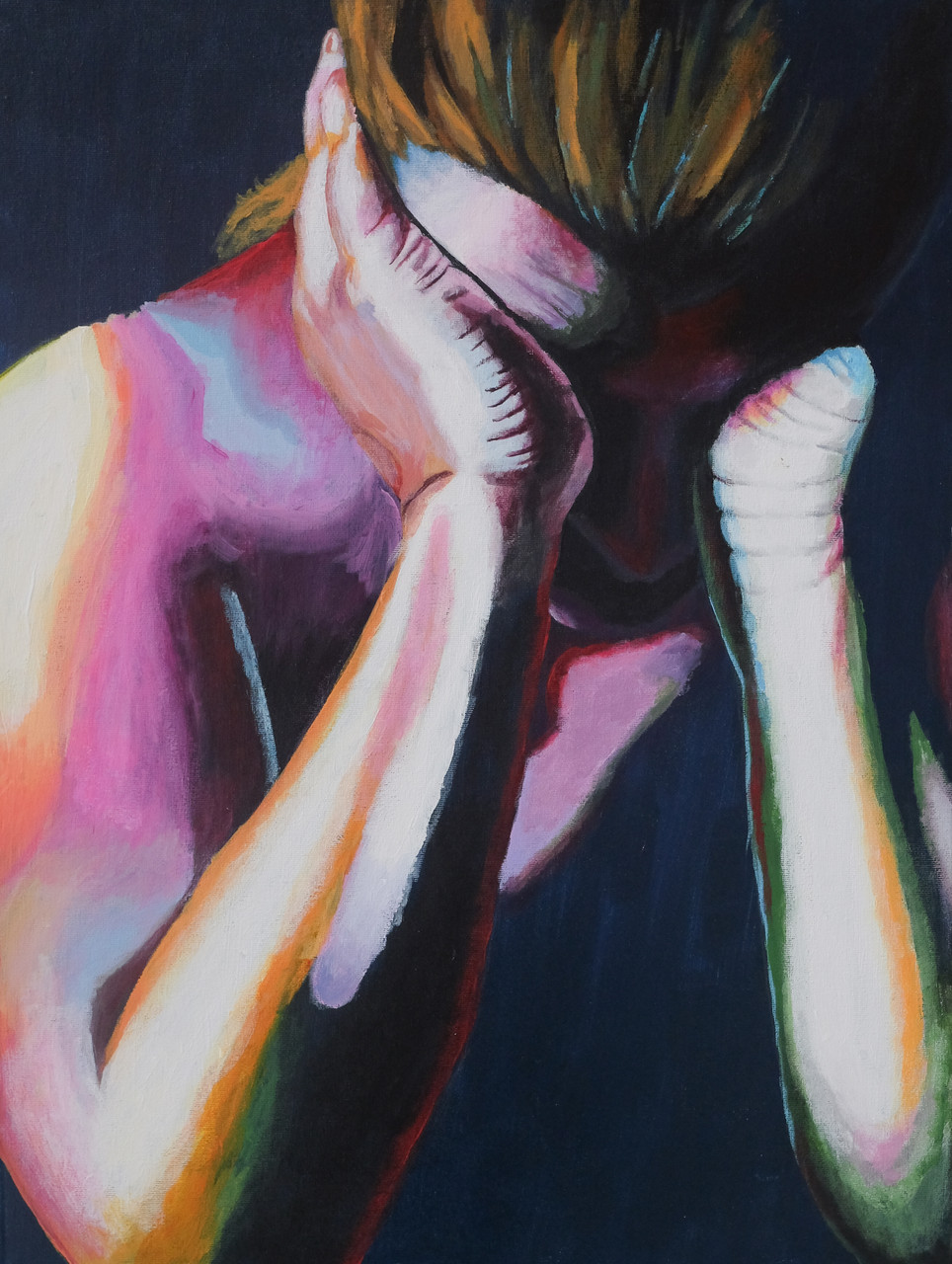 A woman holds her face in her hands.
