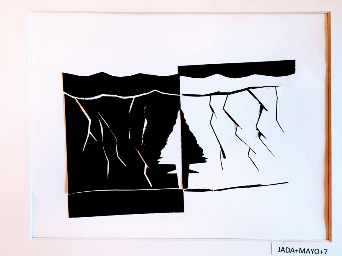 Black and white paper cutouts forming what looks like lightning.