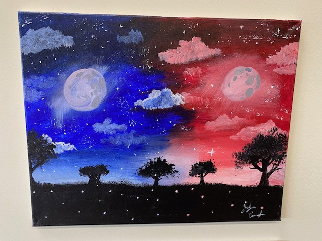 An acrylic painting of a blue night sky on the left side and a red night sky on the right side. There is a black silhouette of trees on the bottom.