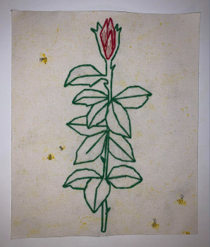 Embroidered rose in its closed state against a slightly yellow tinted background.