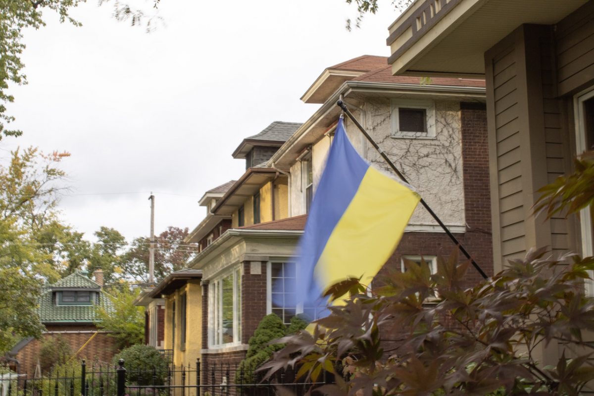 Photo of residential homes with a Ukrainian flag
