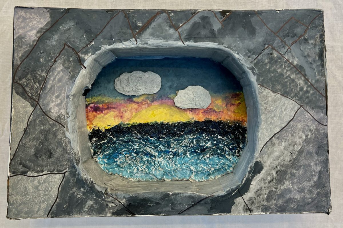 Water with sunset and clouds within an oval.