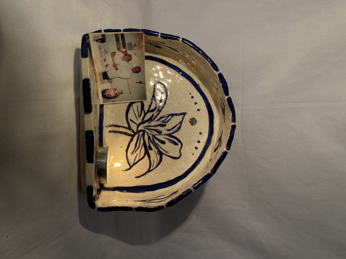 Cultural ceramic with a tea light and family photo inside