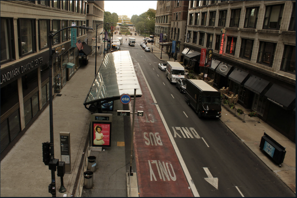 Downtown street with bus stop.