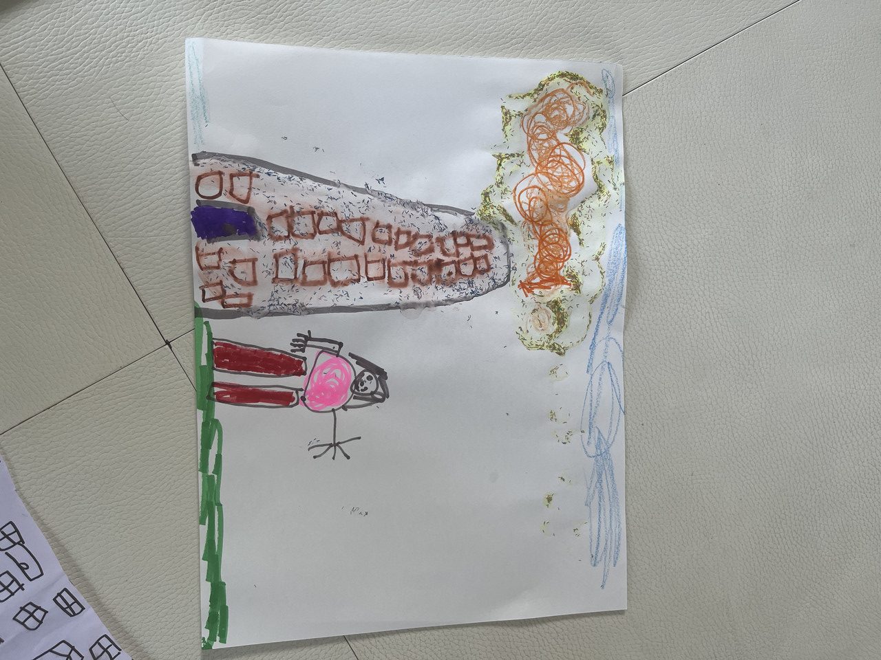 Drawing of person standing next to a building using markers and glitter glue.