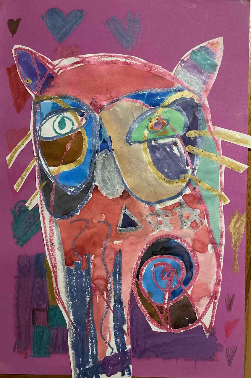 Collage cat with different shapes and colors to form the cat. Blue, green, and pink shades.