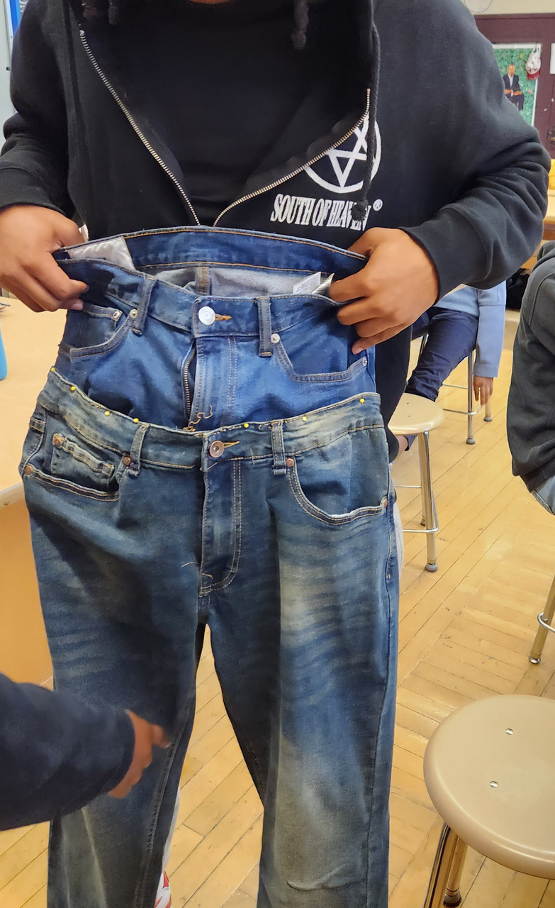 The waist of one pairs of jeans attached to another