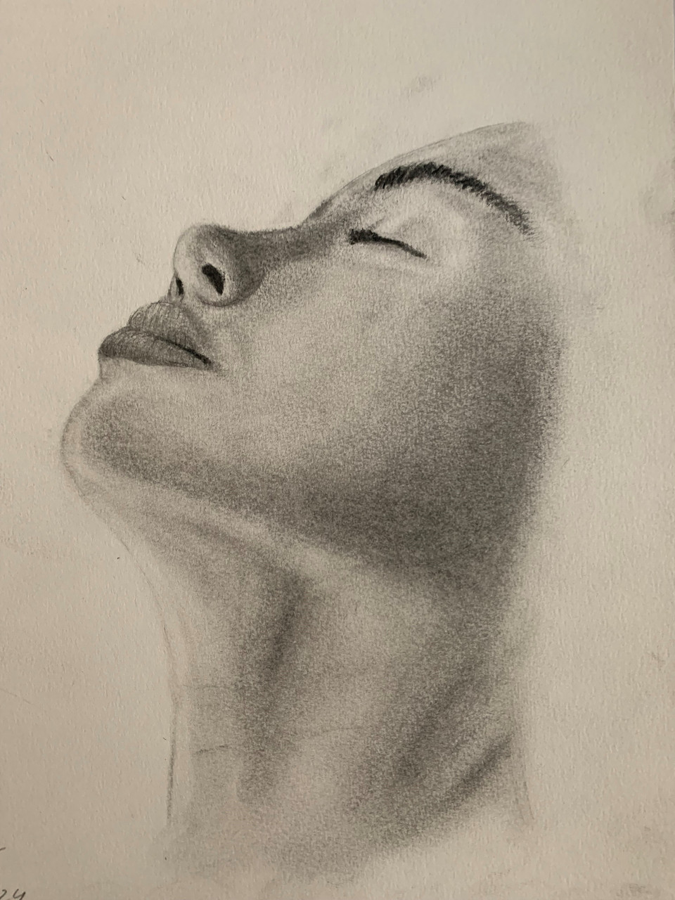 headshot of a women's head tilted up with her eyes closed