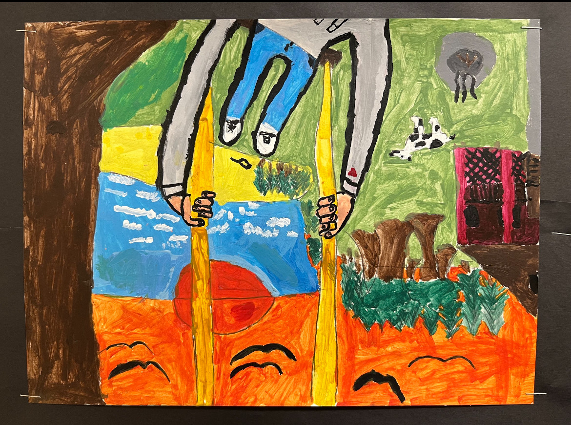 Person with a grey sweater upside down on a swing with a farm in the background.