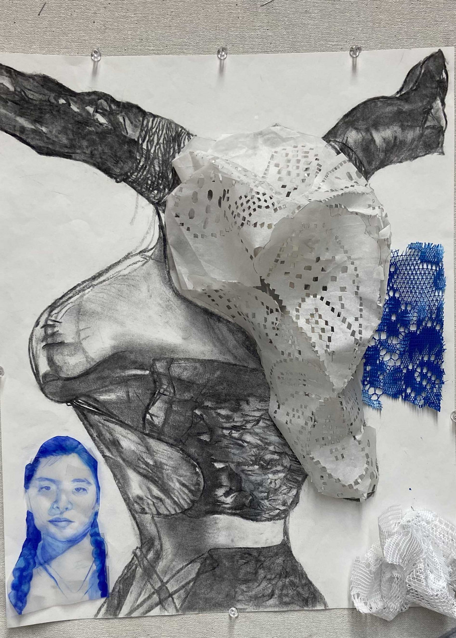 Painting/drawing of an unidentifiable object with a women in blue in the bottom corner.