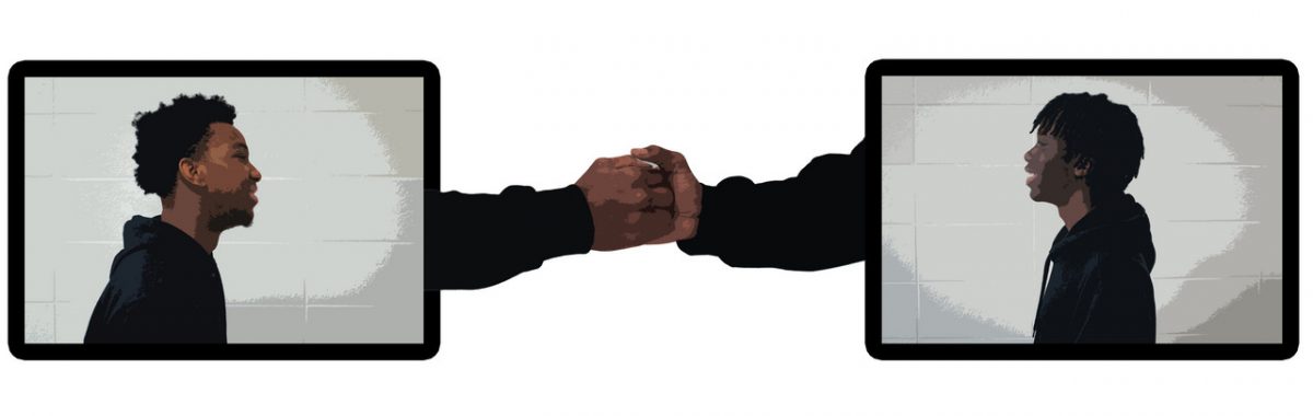 Two men facing each other in boxes with two hands shaking in between the boxes.