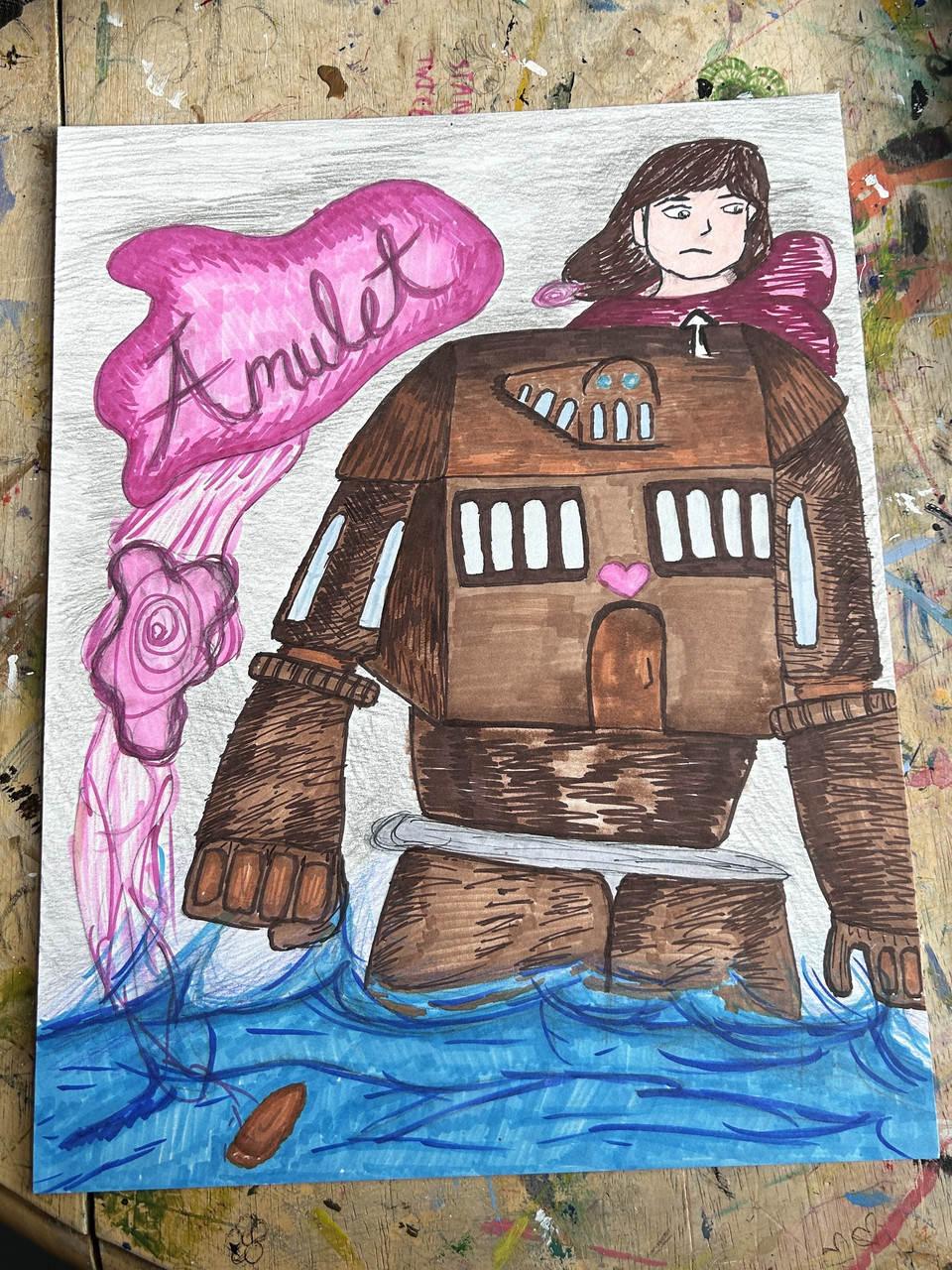 Girl in a pink shirt inside a copper robot in the ocean. It says Amulet on the top left corner with a pink glow