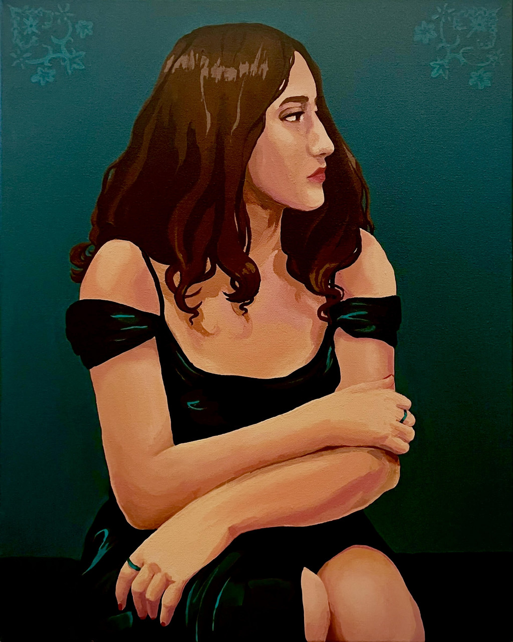 Portrait of woman in black dress with brown hair looking over her shoulder.