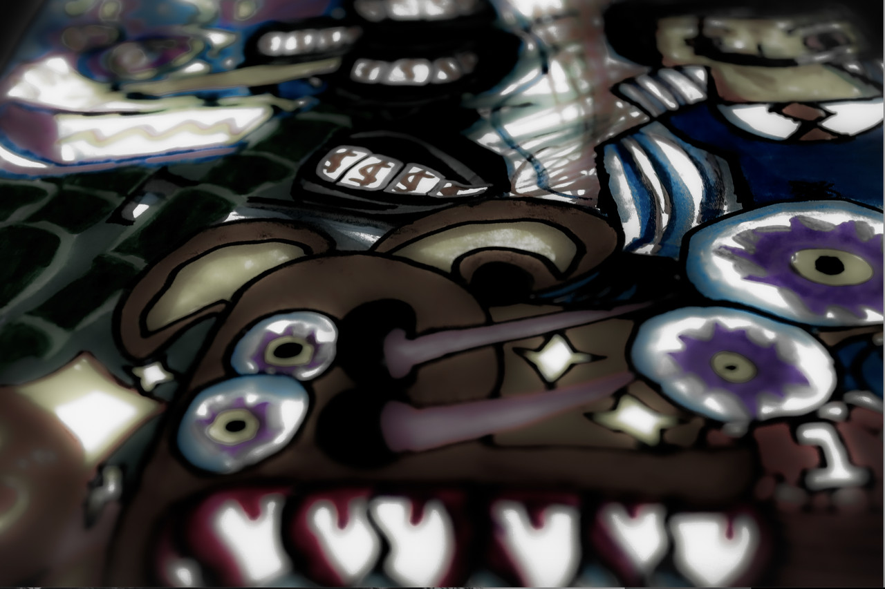 Photo of brown and blue drawing of characters. Light reflects off paper.