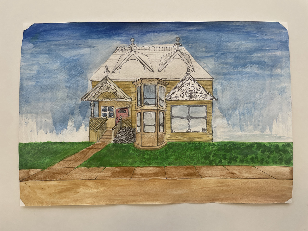 Clear blue skies with a singular beige house in a grassy green field