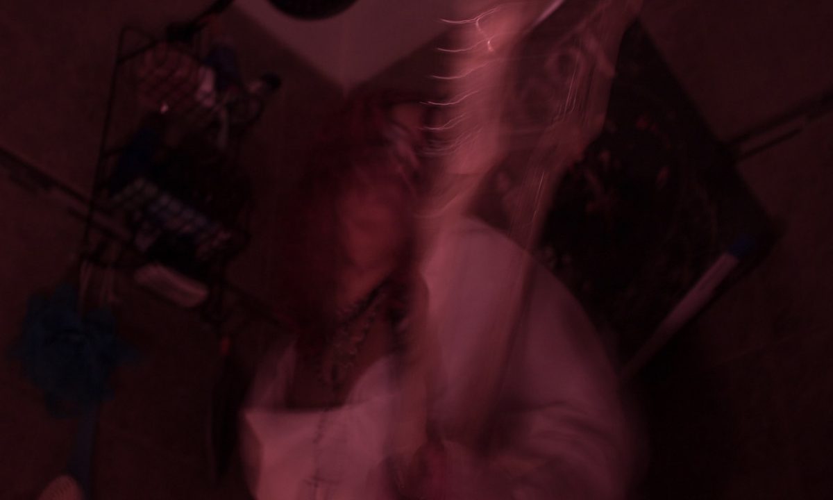 Pink illuminated hazy image of a room.