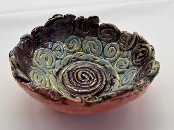Ceramic bowl with spiral patterns made from coils.