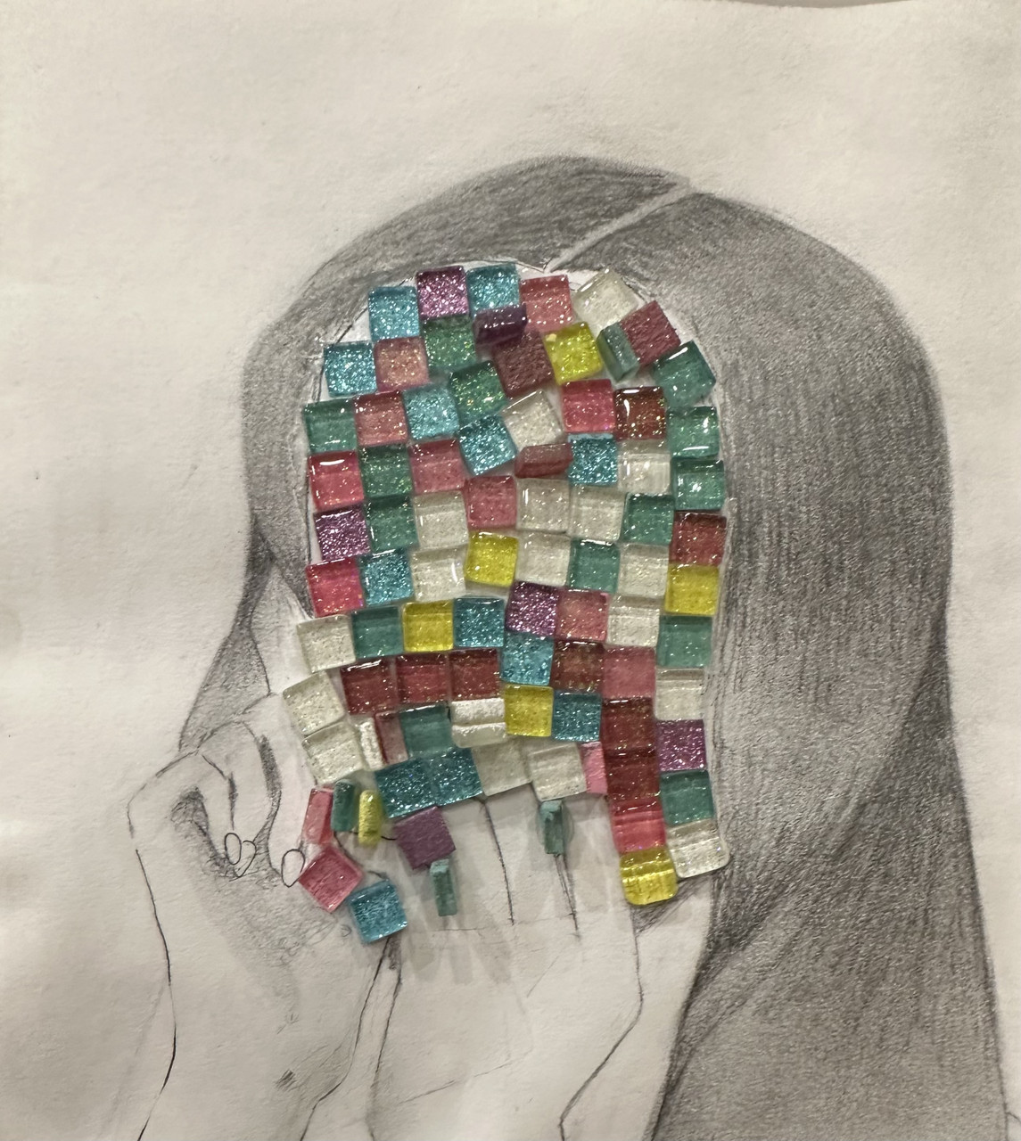 Girl covering her face with blue, yellow, purple, and pink mosaic tiles covering it