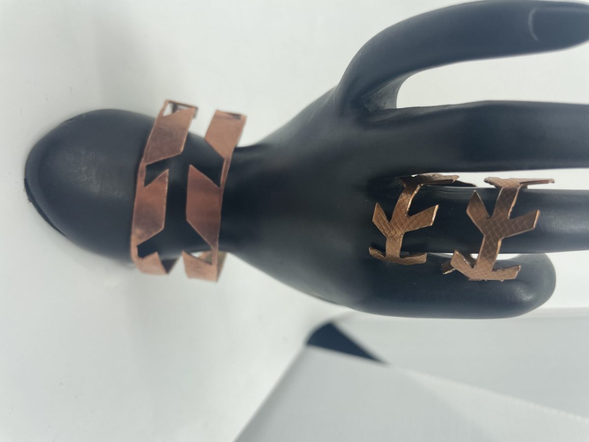Copper colored bracelet and rings that resemble a tree branch