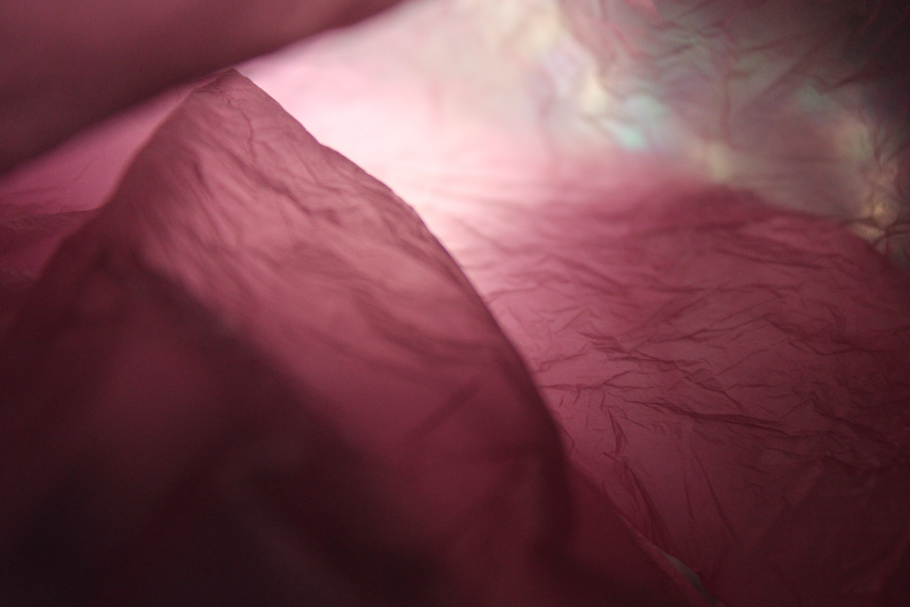 A pink abstract picture of a fabriclike texture
