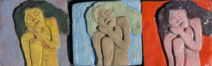 Clay sculpture of three people in different colors.