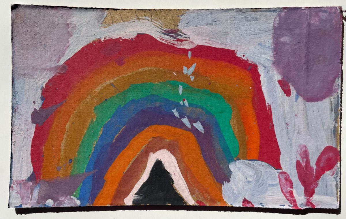 A painting of a rainbow, done on cardboard.