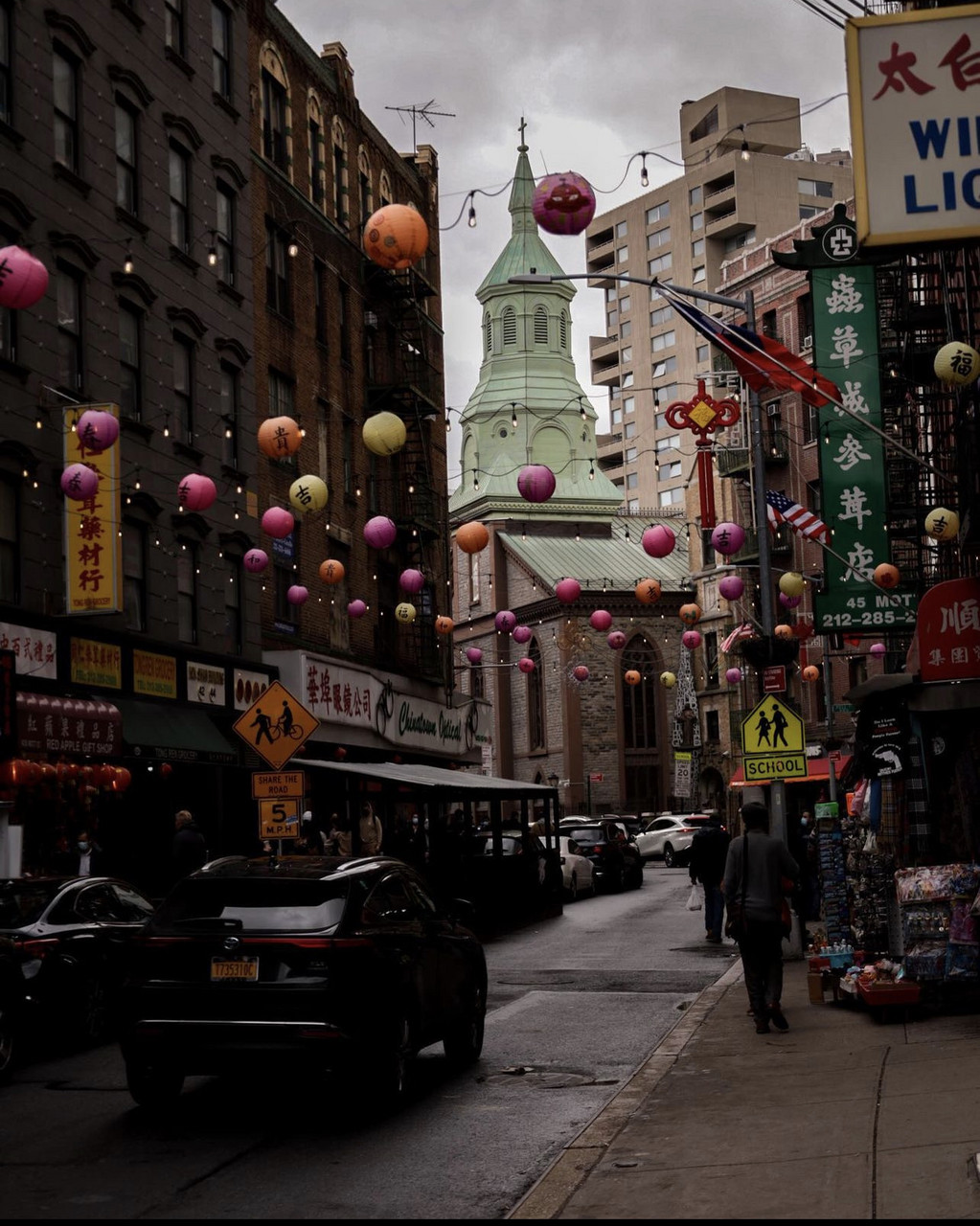Red, orange, and white Chinese lanterns released in the middle of a shopping strip