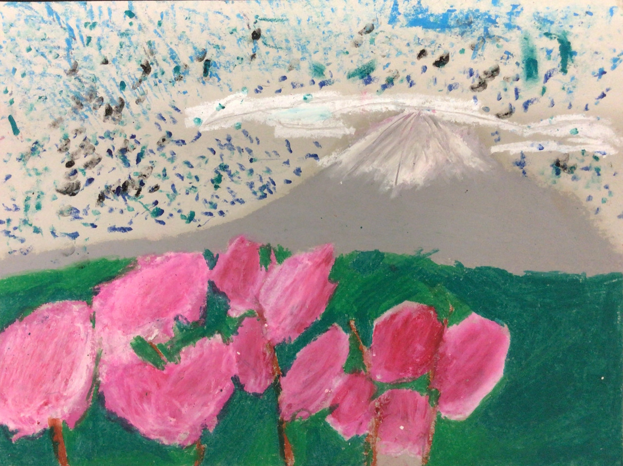 Landscape scene of pink flowers in green flied in front of a grey and white mountain.