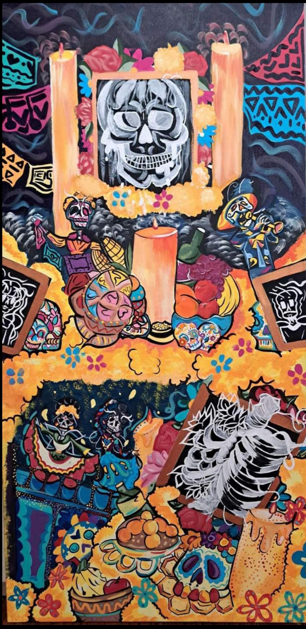 Image of an offrenda with many skulls, marigolds, and candles surrounding larger skull image.