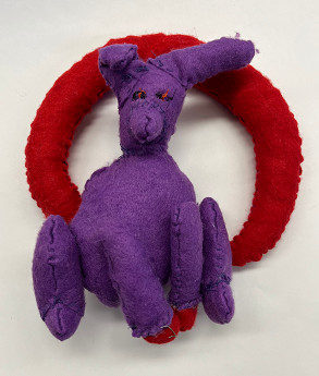 Sculpture of a purple animal with a red ring behind it