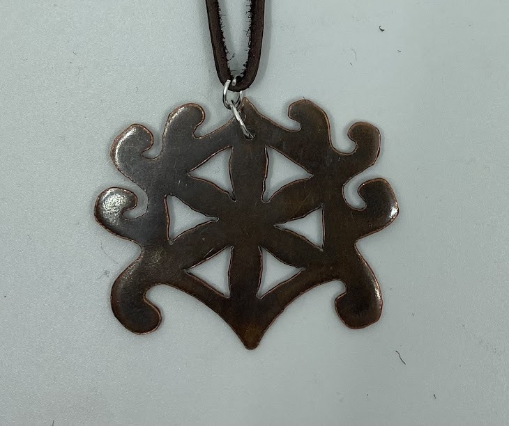 A metal necklace with a round shape