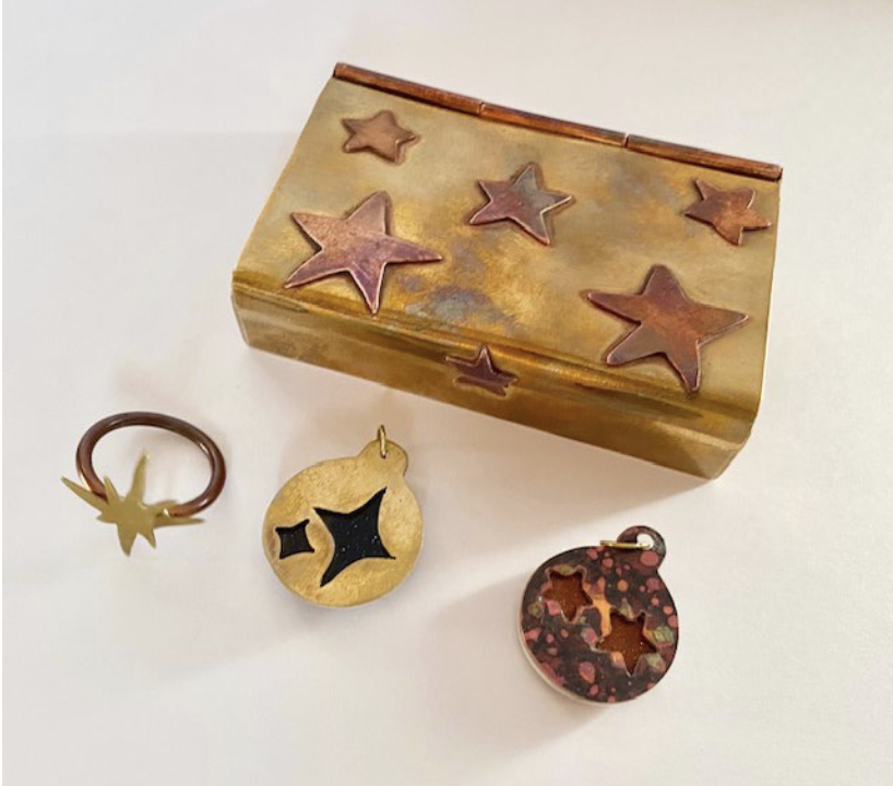 Photo of sculptures including hinged box with stars and three other small star pieces