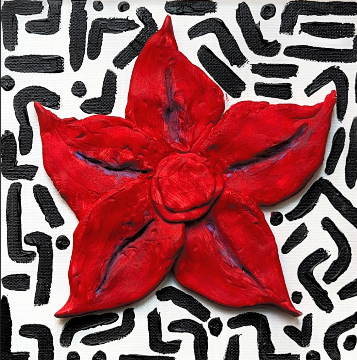 Mixed media with white background and abstract black lines painted on it. Red clay flower attached in middle of canvas