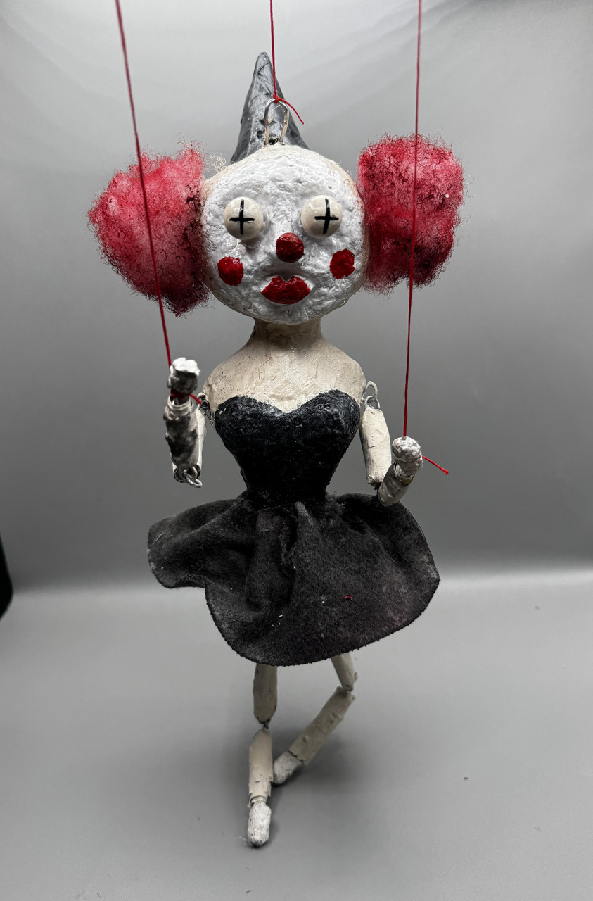 Marionette sculpture of clown in black dress